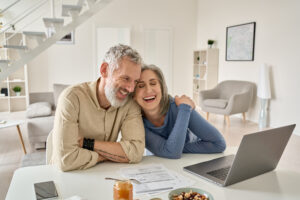 Retirement-aged couple looking at computer.